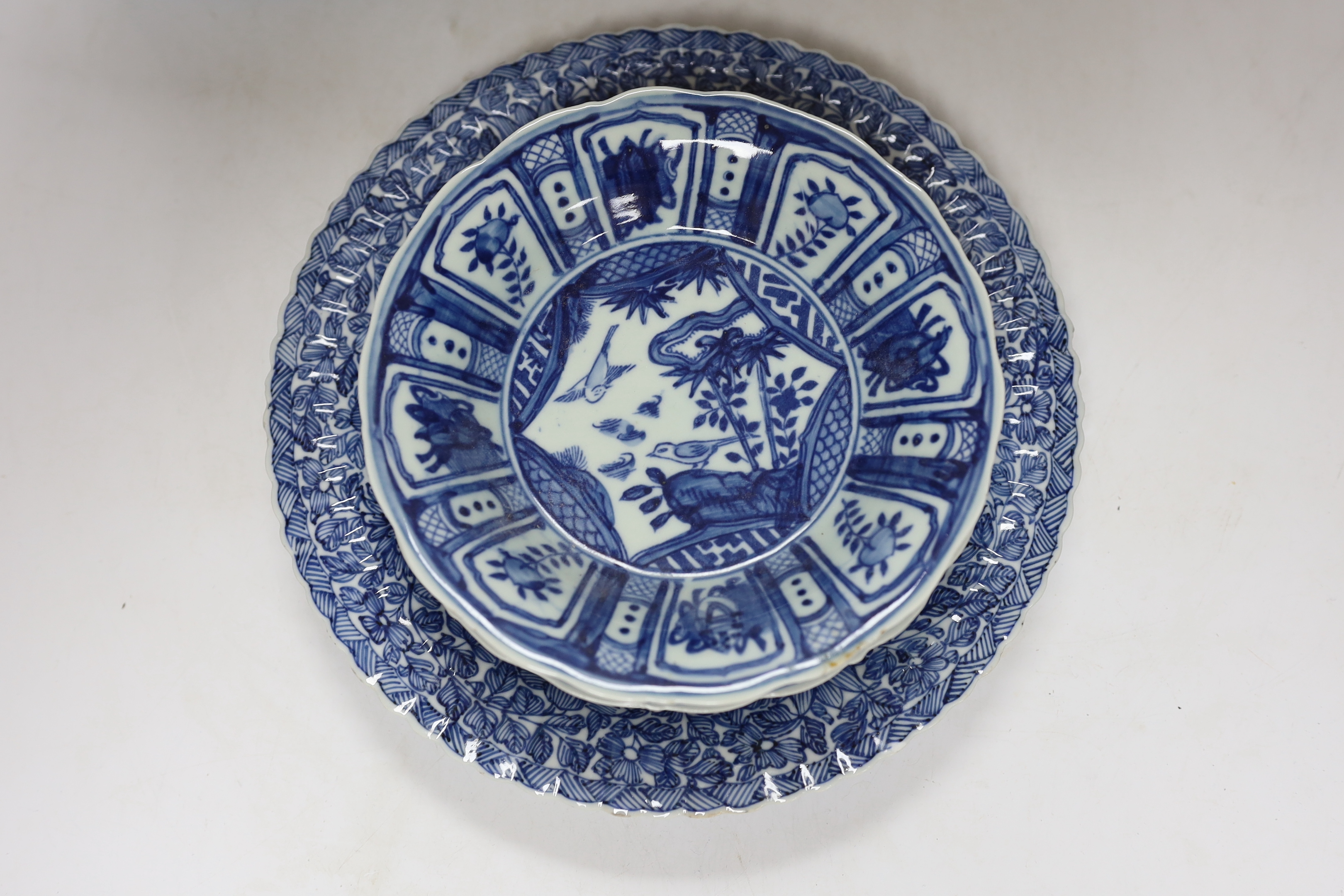 A group of Chinese blue and white dishes and plates and a damaged vase, 30cm